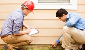 Contractor and home owner checking foundation of house