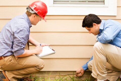 Contractor and home owner checking foundation of house