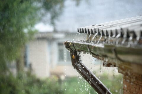 Heavy rain falling into gutters on home