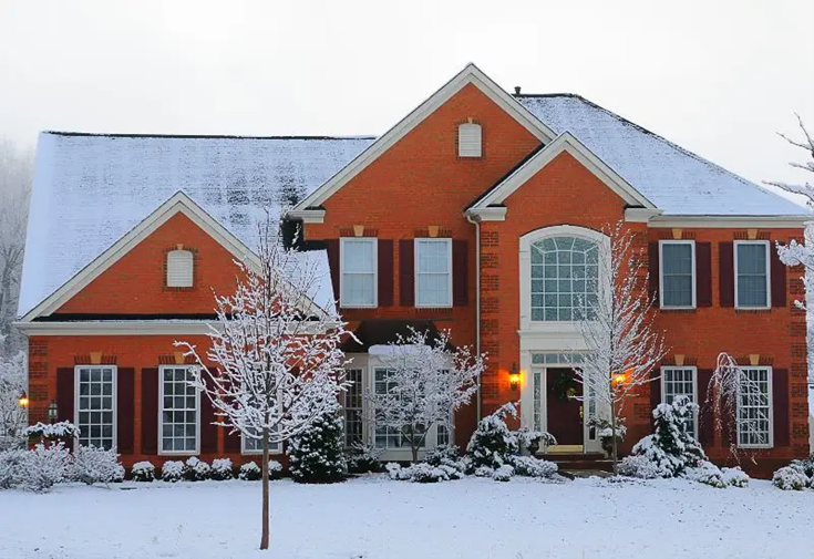 Modern brick house covered in snow in Maryland