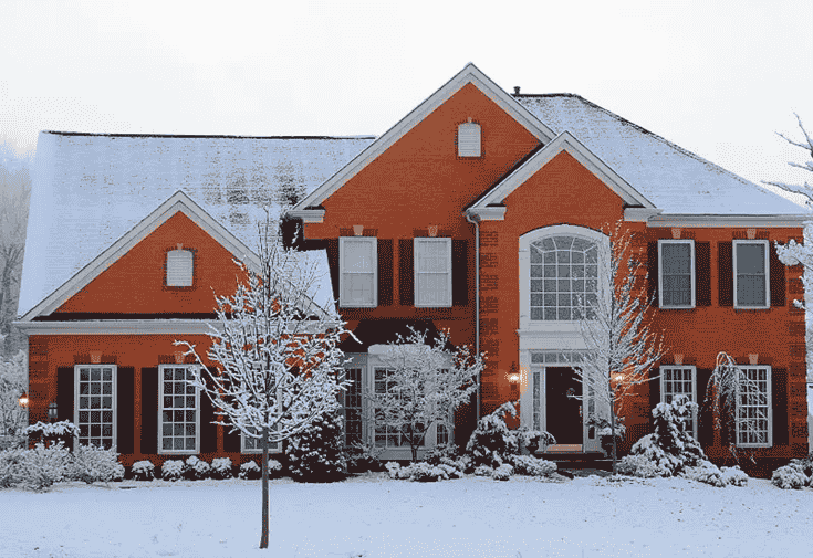 Modern brick house covered in snow in Maryland