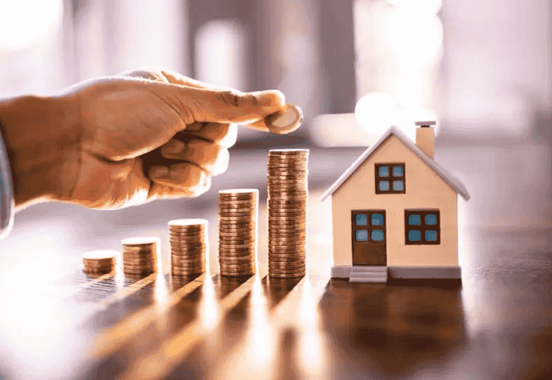 Money next to a house, indicating an increase in property value in Maryland