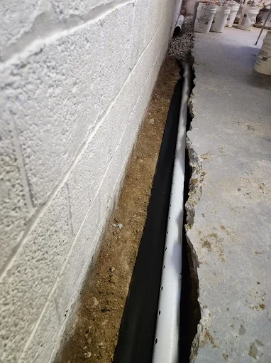 Interior basement drain tile system installation.