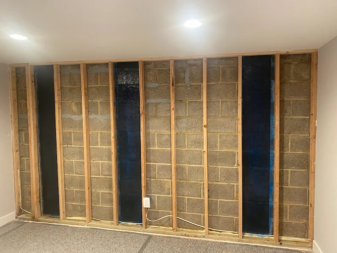 Basement wall repaired with vertical carbon fiber straps.
