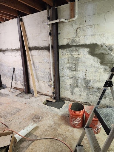 Steel I-beams installed to stabilize foundation wall.